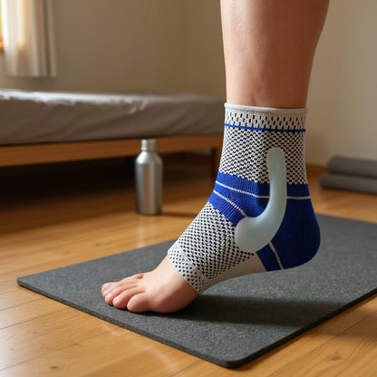 Person wearing a blue and white ankle support brace on a yoga mat.