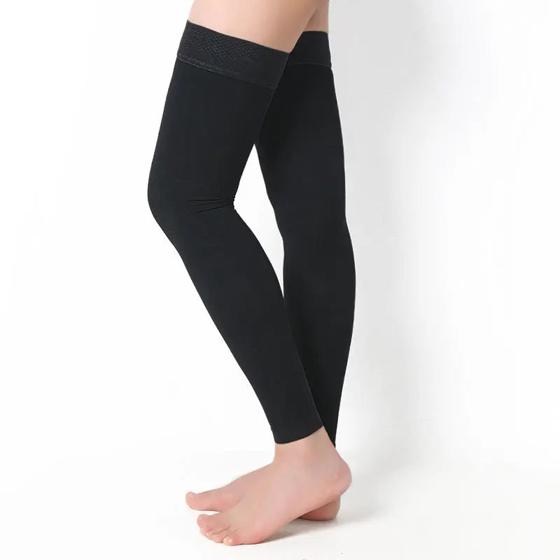 Black compression leg sleeves on a white background