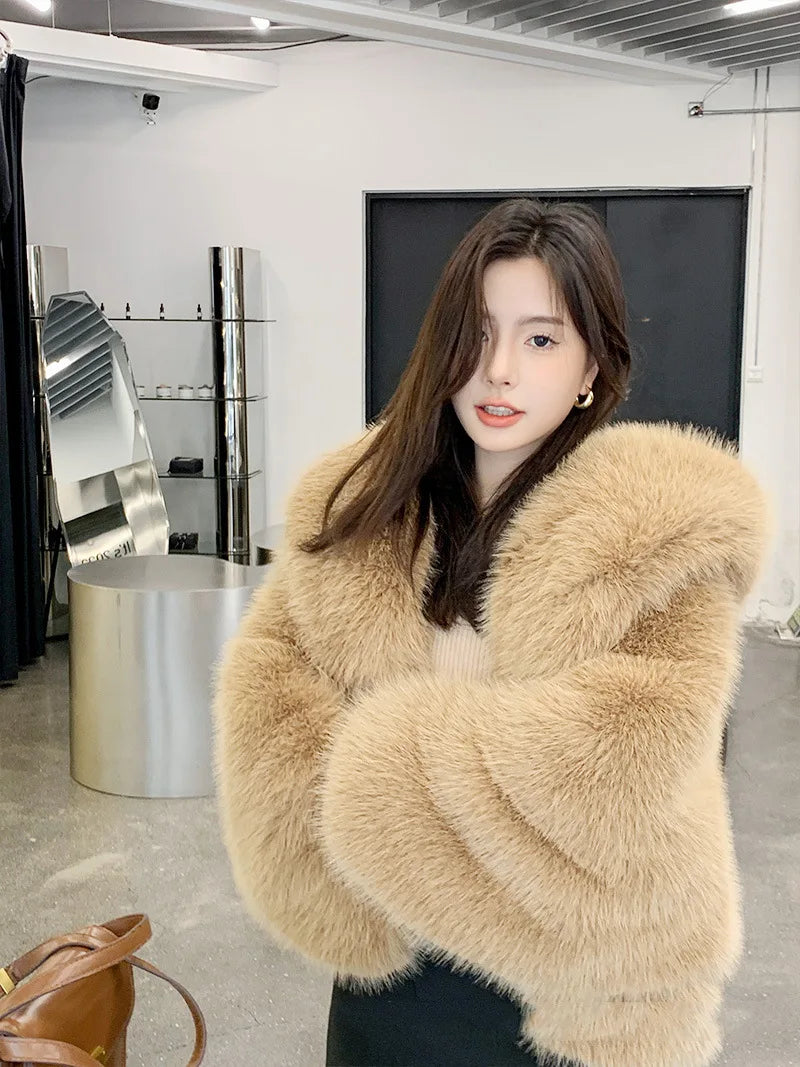 Woman wearing a beige fur coat in an indoor setting