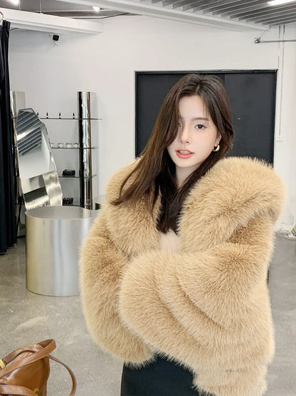 Woman wearing a beige fur coat in an indoor setting