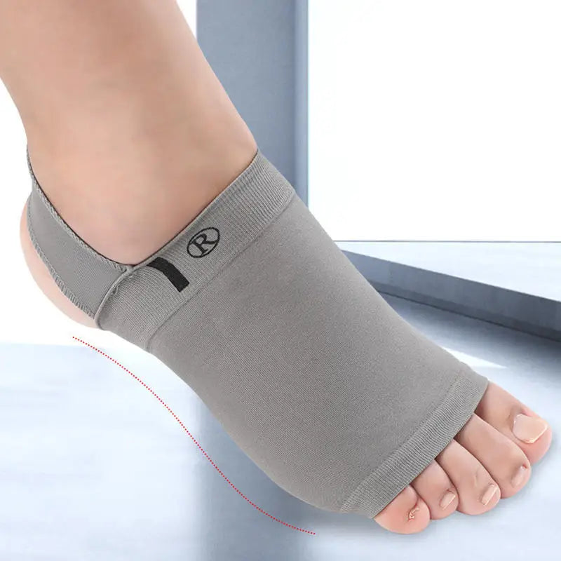Gray toe separator worn on a foot against a light background