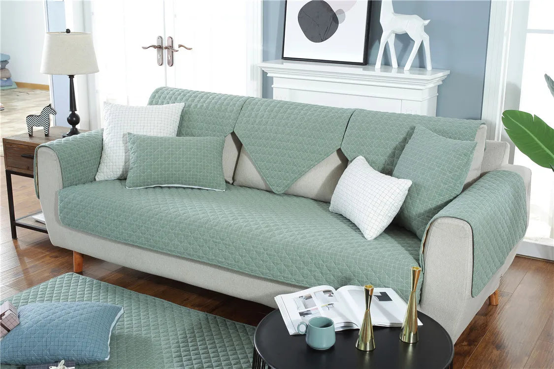 Green sofa with cushions in a living room setting