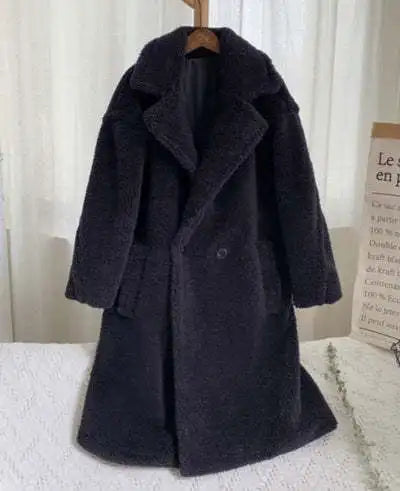 Dark gray coat on a hanger against a white curtain background