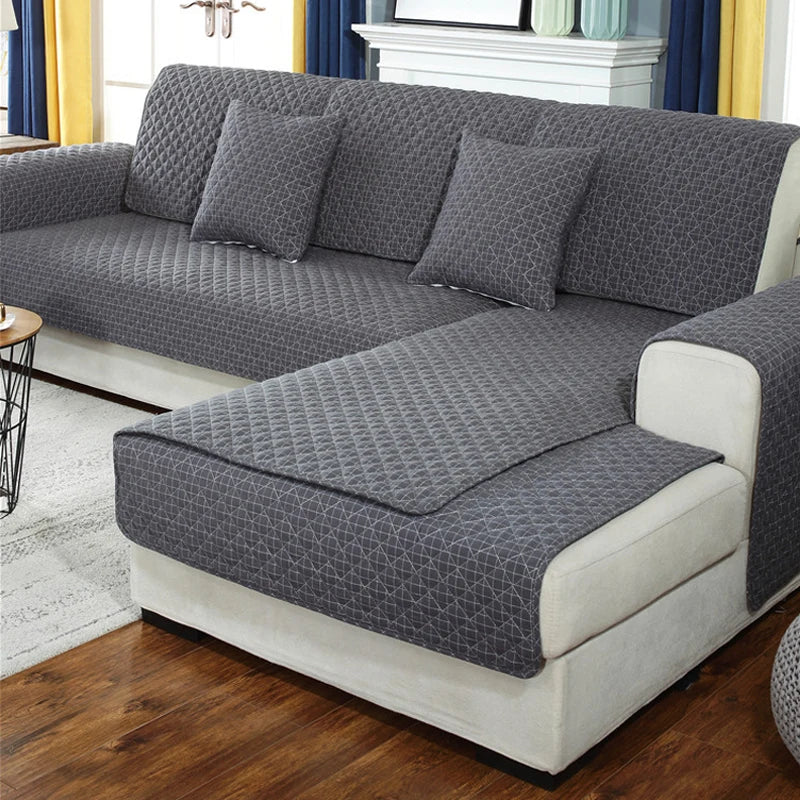 Gray textured sofa cover on a sectional sofa in a living room setting.