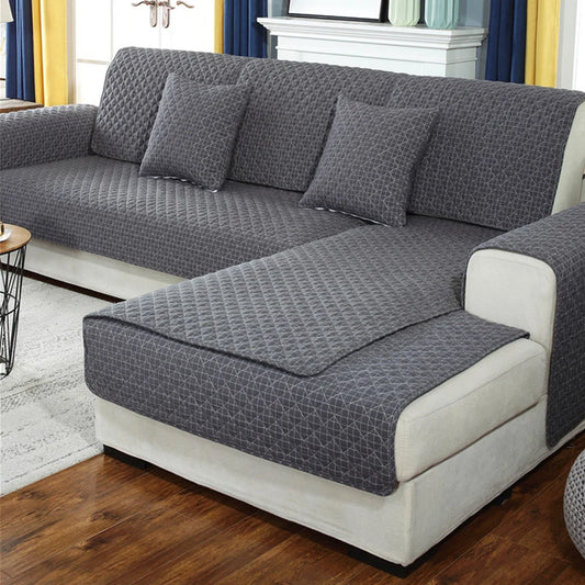 Gray textured sofa cover on a sectional sofa in a living room setting.