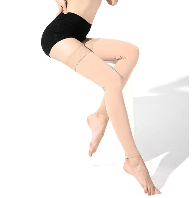 Person wearing beige tights sitting on a white stool against a white background