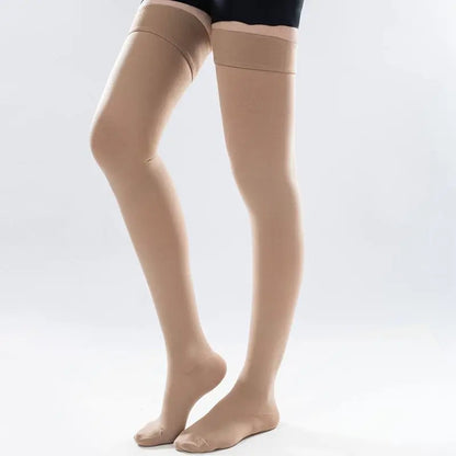 Beige compression stockings worn by a person on a white background
