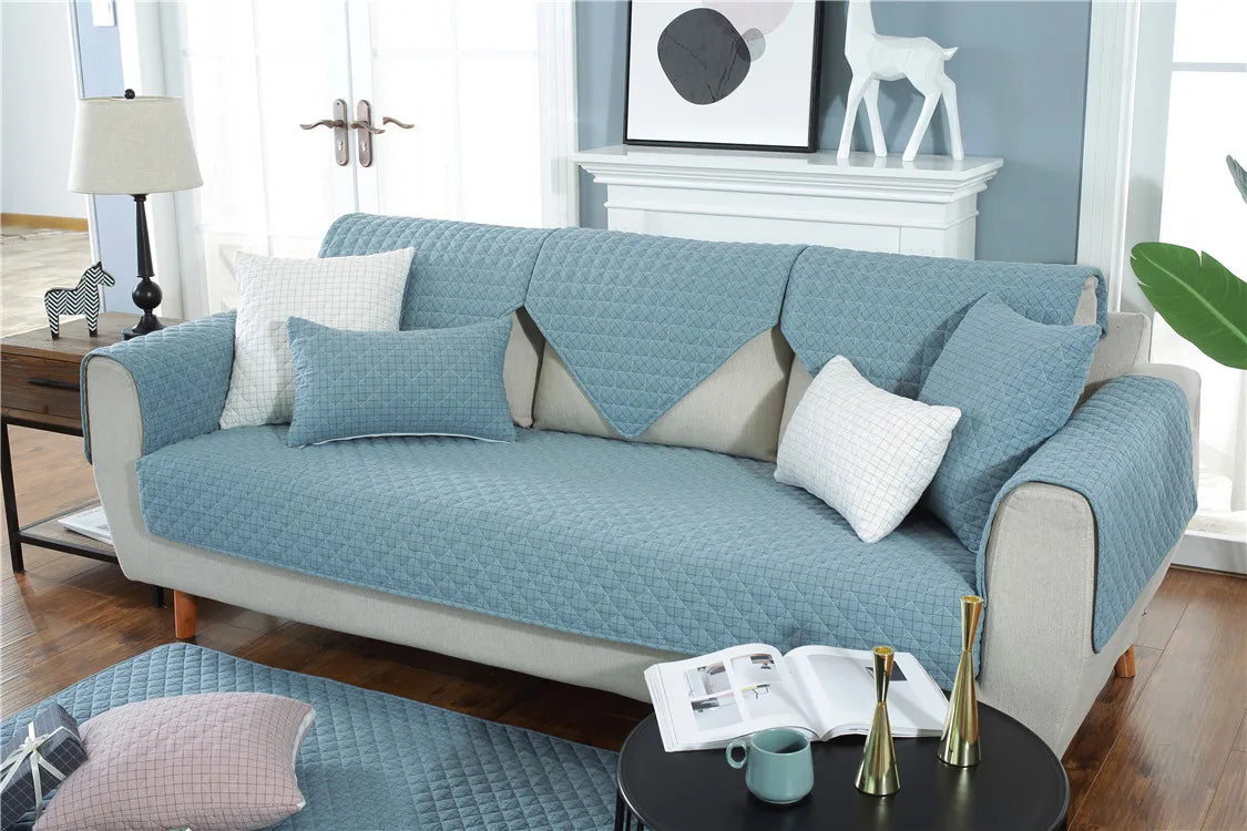 Blue sofa with matching cushions in a living room setting