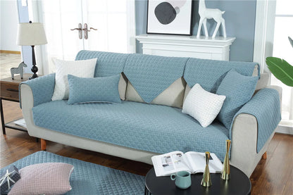 Blue sofa with matching cushions in a living room setting